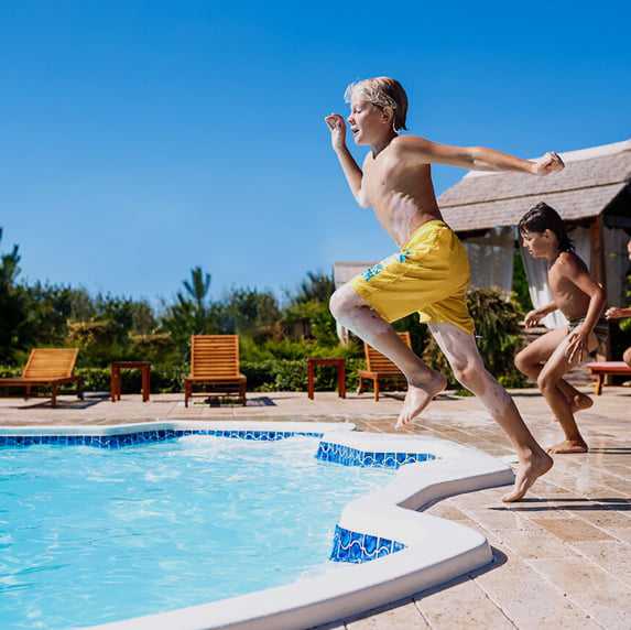 boy jumping into fiberglass pool Tulsa oklahoma