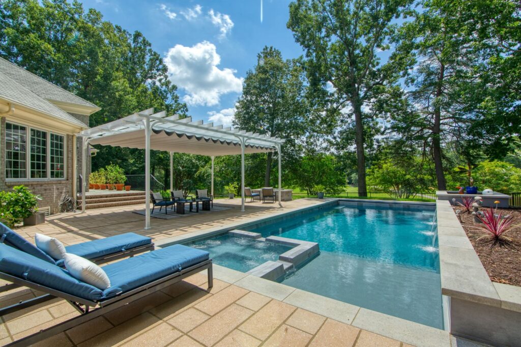 002. River Pools X36 in Granite Gray with cascade, concrete paver patio, and natural stone coping