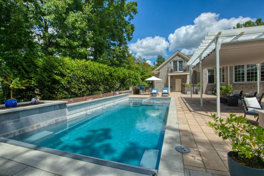 005. River Pools X36 in Granite Gray with cascade, concrete paver patio, and natural stone coping