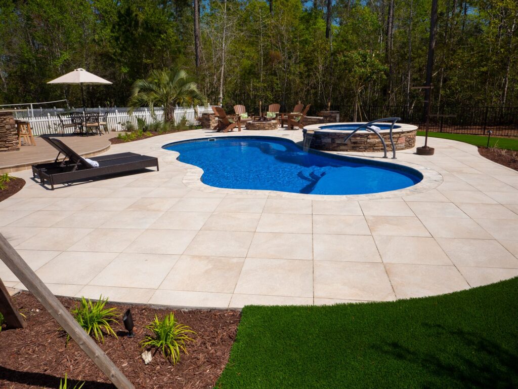 009. River Pools I30 + RS08 with spillway in Maya Shimmer with natural stone patio and coping