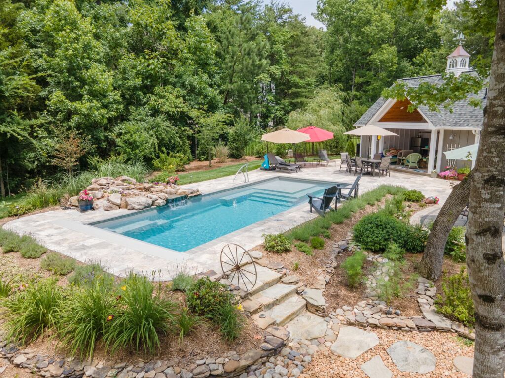 009. River Pools M35 in Granite Gray with a cascade, natural stone patio, and concrete paver coping