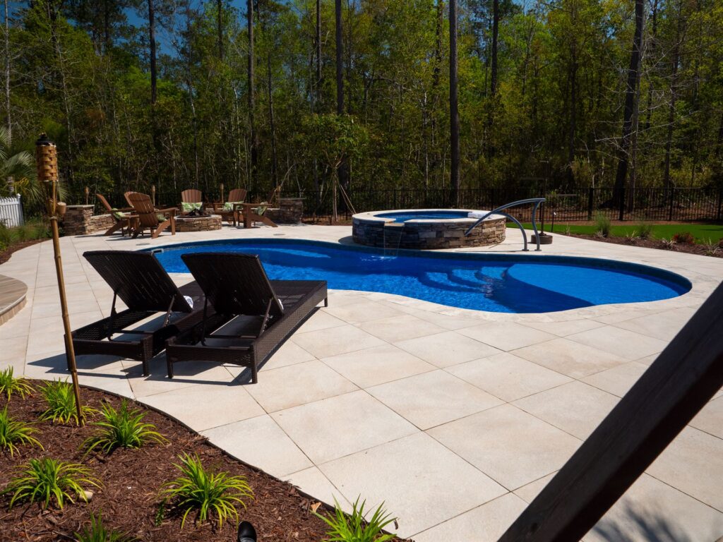 012. River Pools I30 + RS08 with spillway in Maya Shimmer with natural stone patio and coping