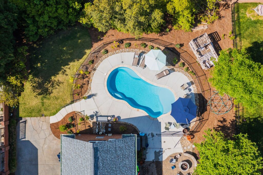 014. River Pools I30 in Caribbean Sparkle with brushed concrete and natural stone coping