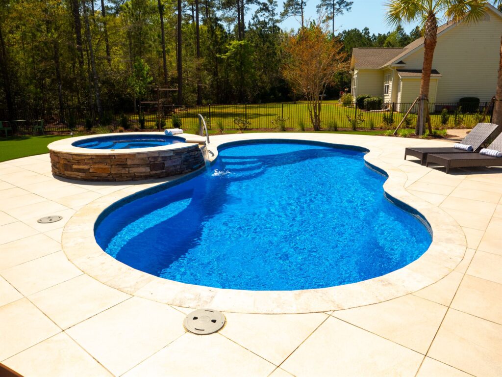 016. River Pools I30 + RS08 with spillway in Maya Shimmer with natural stone patio and coping