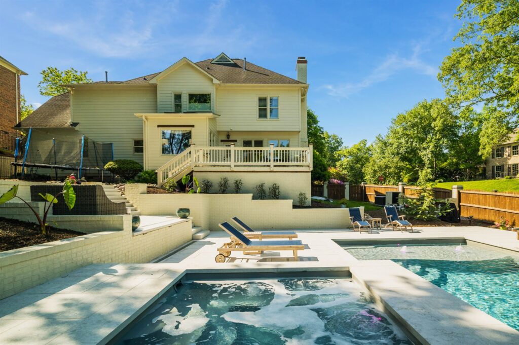 020. River Pools D40 + SS08 in Granite Gray with cascades, bubblers, and natural stone patio and coping