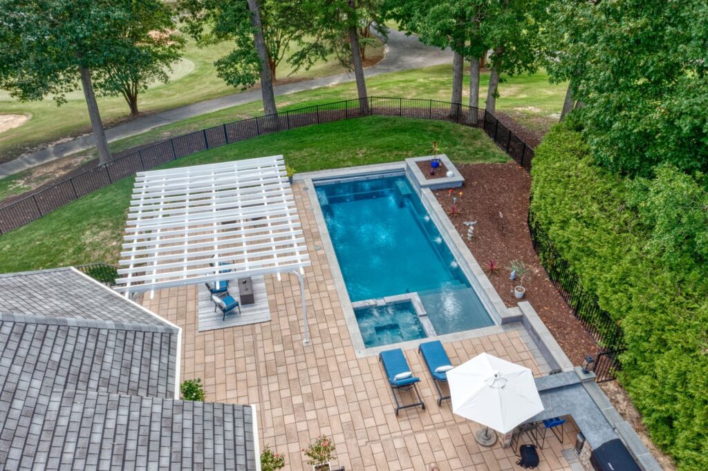 020. River Pools X36 in Granite Gray with cascade, concrete paver patio, and natural stone coping